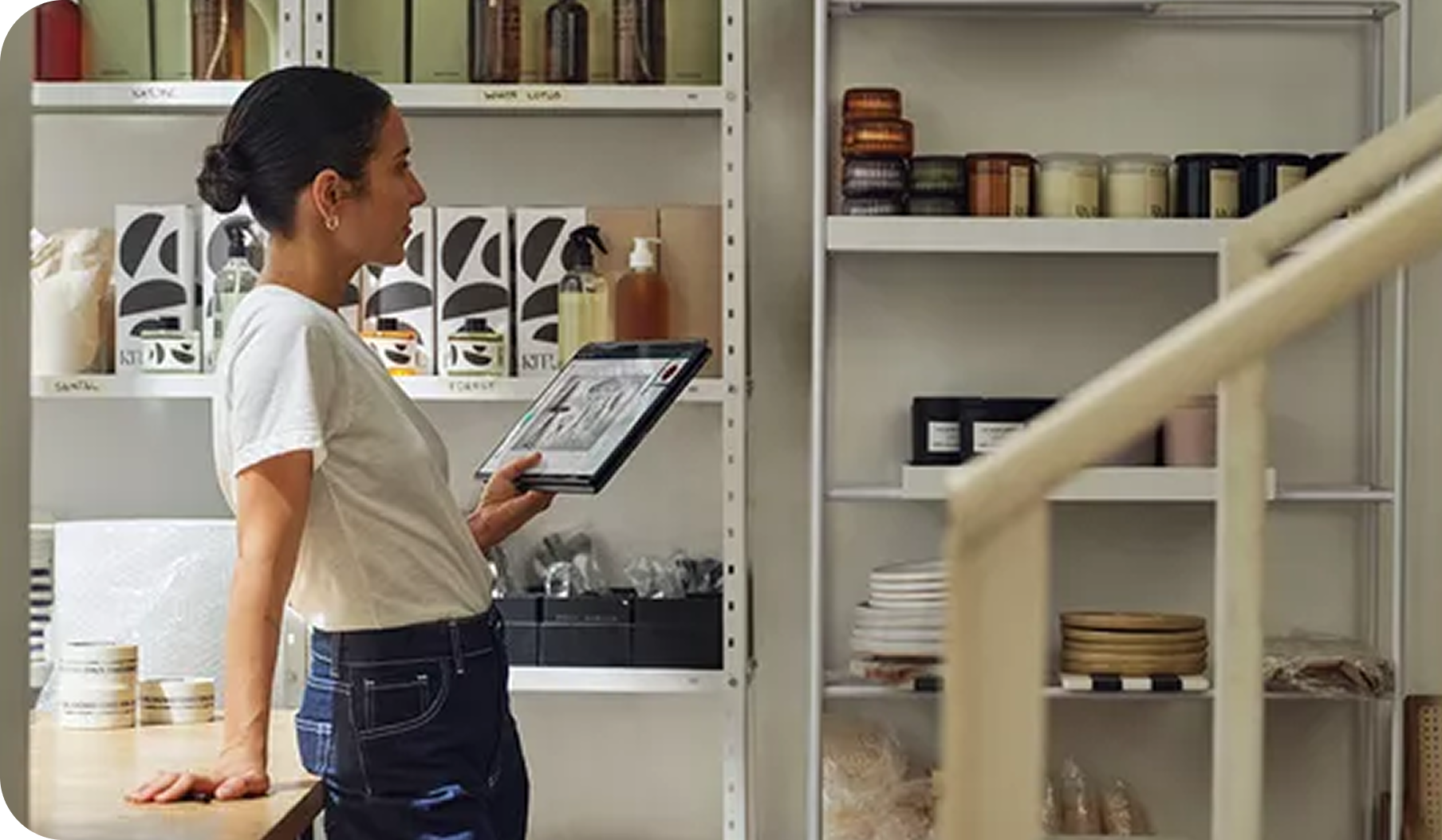 A women holding book ultra in a pantry area 